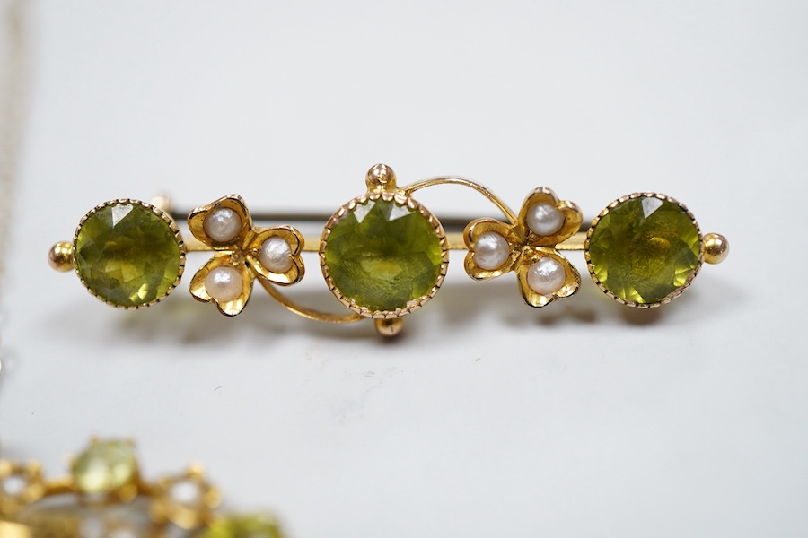 Two Edwardian peridot and seed pearl jewels, early 20th century, comprising: a bar brooch and a pendant, each of foliate design, set with circular-cut peridots and seed pearls, mounted in gold, brooch length 3.5cm, maker